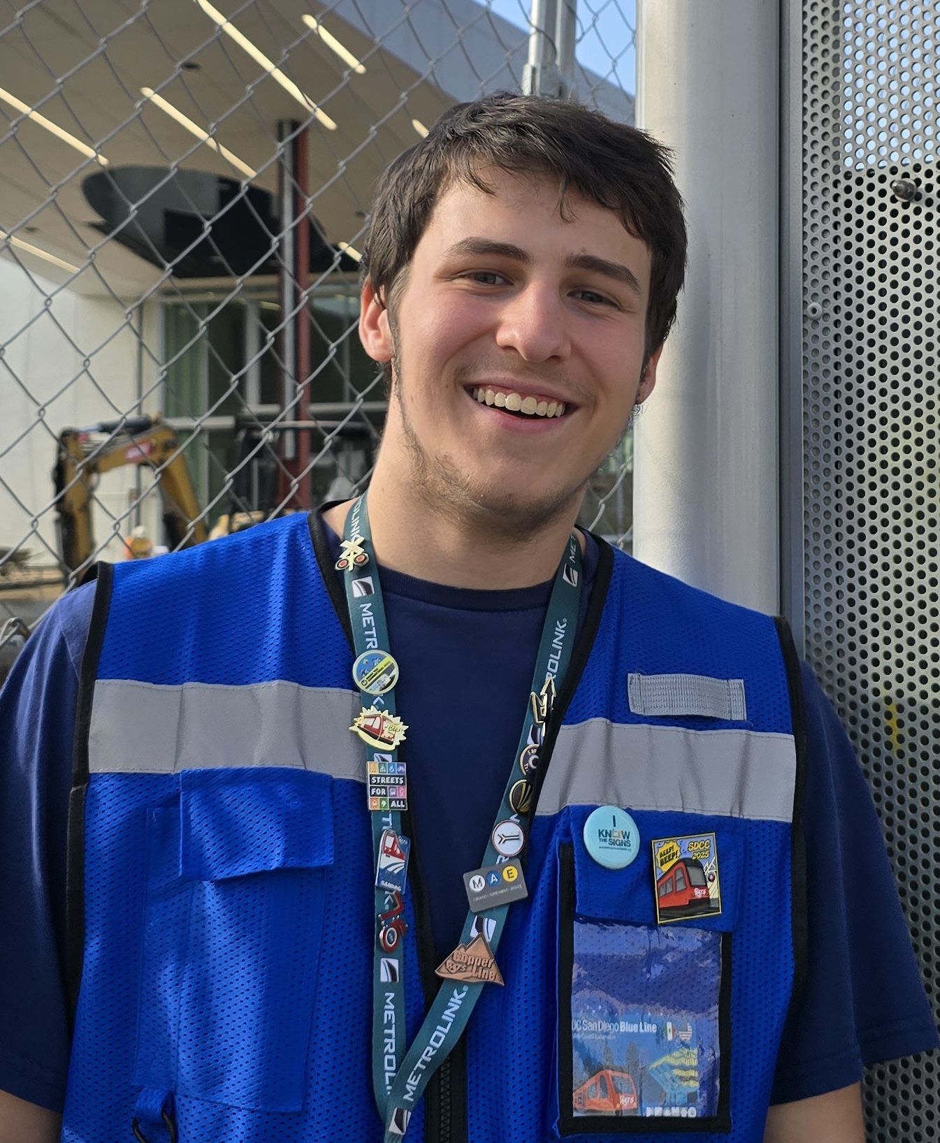 Portrait of Samuel wearing a blue hi-vis vest